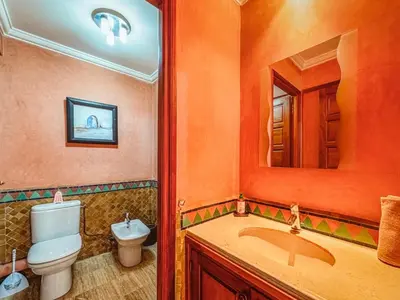 a bathroom with a toilet and a sink and a mirror at Timeless Hideaway in Marrakech