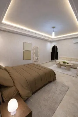 a bedroom with a large bed and a couch at Spacious studio with pool Guéliz in Marrakech