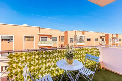 a patio with a table and chairs on a balcony at Appartement spacieux 83 m carré Wi Fi Marrakech in Marrakech
