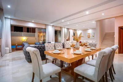 a dining room with a table and chairs at Villa de luxe et plaisir in Marrakech