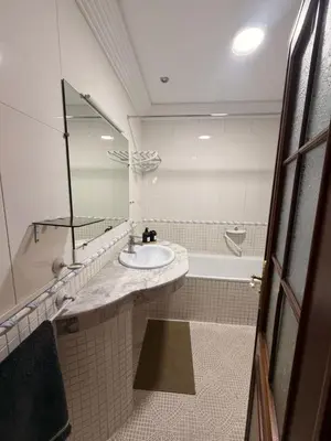 a bathroom with a sink and a tub and a mirror at Tay Home in Marrakech