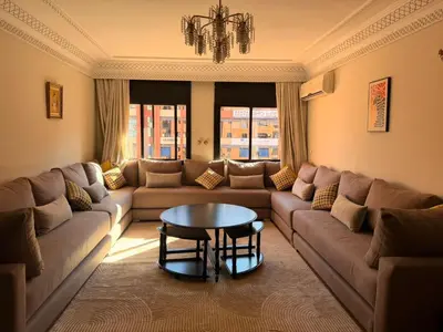a living room with a couch and a table at Tay Home in Marrakech