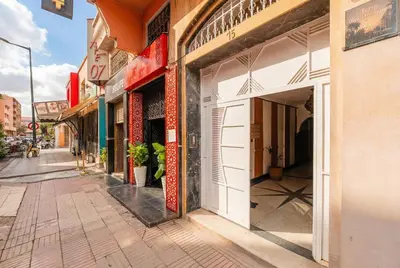 an empty street in a city with shops at Modern & Cozy Apartment 2 min Carré Eden Guéliz in Marrakech