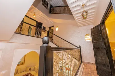 a staircase in a home with a wrought iron railing at Riad Marrakech 4-bedroom Riad in the heart of Marrakesh with Pool in Marrakech