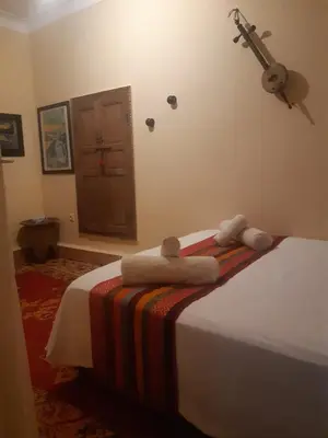a bedroom with a bed with towels on it at Riad ICA in Marrakech
