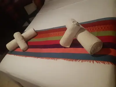 two toilet paper rolls on top of a colorful blanket at Riad ICA in Marrakech