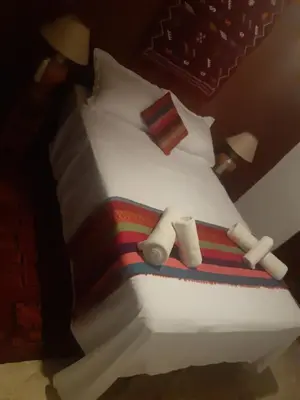 a large white bed with two towels on it at Riad ICA in Marrakech