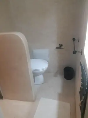 a small bathroom with a toilet and a sink at Riad ICA in Marrakech