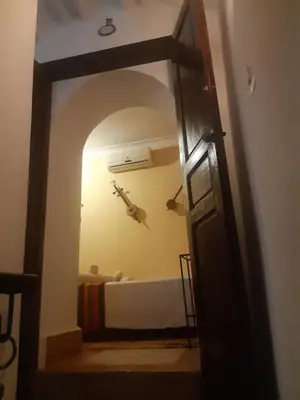 a door leading into a room with a bed at Riad ICA in Marrakech
