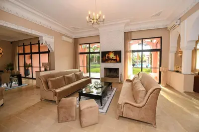 a large living room with couches and a fireplace at Royal Moroccan House in Marrakech