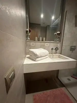 a bathroom with a sink and a mirror at Guéliz 5 min away - Quiet - Pool & Parking in Marrakech