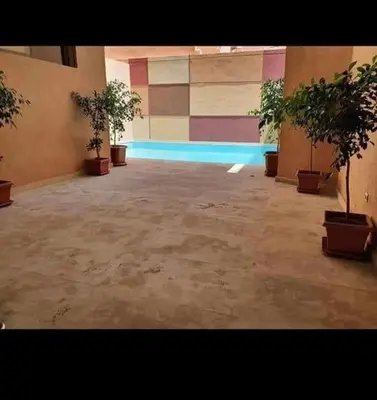 a room with a swimming pool with potted plants at Guéliz 5 min away - Quiet - Pool & Parking in Marrakech
