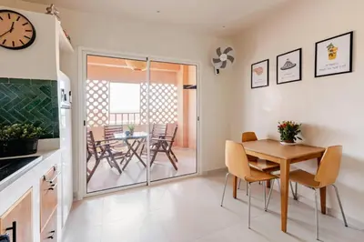 a kitchen and dining room with a table and chairs at 3 chambres lumineux au centre de Marrakech in Marrakech