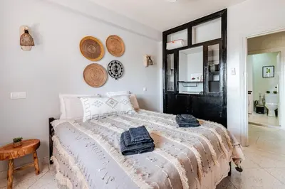 a bedroom with a bed with towels on it at 3 chambres lumineux au centre de Marrakech in Marrakech