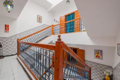a staircase in a house with a wooden railing at Riad Palm Oasis Marrakech in Marrakech