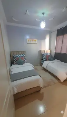 a bedroom with two beds in a room at Pied-à-terre Calme & Climatisé à 5 min du Centre in Marrakech