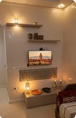 a living room with a tv on a wall at Pied-à-terre Calme & Climatisé à 5 min du Centre in Marrakech