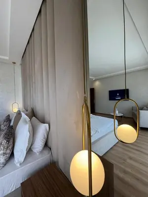 a room with two beds and two lights on the wall at Villa 60 Saphir in Marrakech