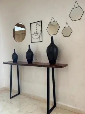a table with two vases and a mirror on a wall at Villa 60 Saphir in Marrakech