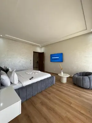 a bedroom with a large bed and a couch at Villa 60 Saphir in Marrakech