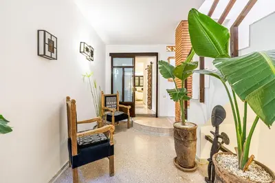 a hallway with chairs and plants in a room at Riad Kenous - Exclusive&New -6 pax- Pool & Breakfast in Marrakech