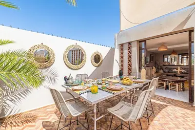 a dining room with a table and chairs on a patio at Riad Kenous - Exclusive&New -6 pax- Pool & Breakfast in Marrakech