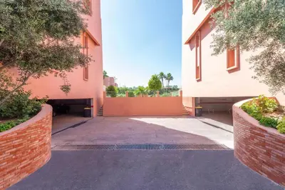 an empty alleyway between two buildings with trees at Marrakech Cozy Family Home piscine et wifi in Marrakech