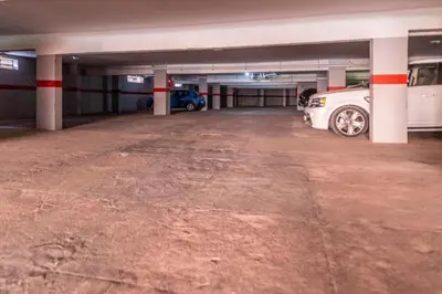 a parking garage with two cars parked in it at Marrakech Cozy Family Home piscine et wifi in Marrakech