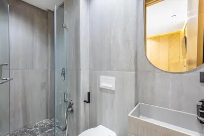 a bathroom with a shower and a toilet and a mirror at Modern apartment, design and cozy relaxing stay in Marrakech