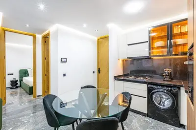 a kitchen with a glass table and chairs at Modern apartment, design and cozy relaxing stay in Marrakech