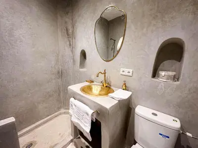a bathroom with a sink and a toilet and a mirror at Riad Green Atlas in Marrakech
