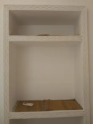 a white shelf with a book on it at Riad Green Atlas in Marrakech