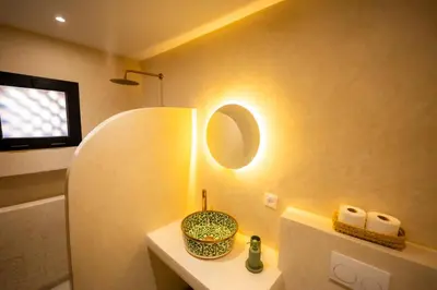 a bathroom with a sink and a mirror on the wall at 1 Bedroom Apartment with Private Garden, Terrace and Pool in Marrakech