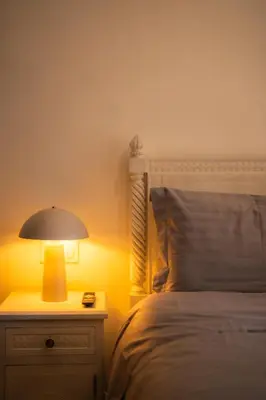 a bedroom with a bed and a lamp on a dresser at 1 Bedroom Apartment with Private Garden, Terrace and Pool in Marrakech