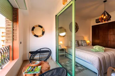 a bedroom with a bed and a mirror at Appartement idéal a l'hivernage in Marrakech