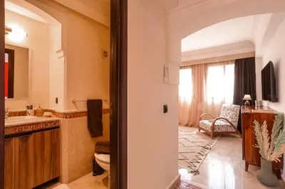 a bathroom with a sink and a mirror at Appartement idéal a l'hivernage in Marrakech