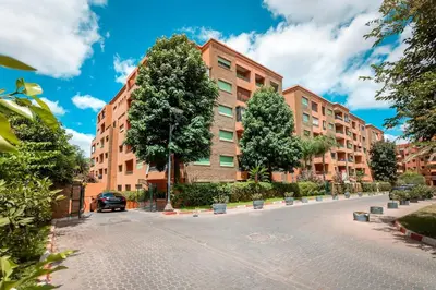 an empty street in front of a building at Appartement idéal a l'hivernage in Marrakech
