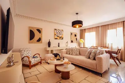 a living room with a couch and a table at Appartement idéal a l'hivernage in Marrakech
