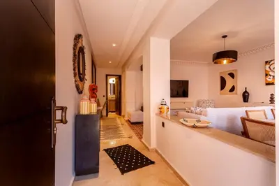 a kitchen and living room with a bed in the background at Appartement idéal a l'hivernage in Marrakech