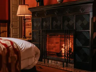 a fireplace in a living room with a fire in it at Casa Memoria in Marrakech