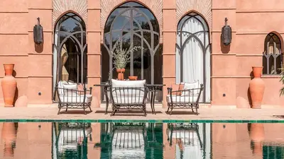 a table and chairs in front of a building at Villa Rehame in Oulad Jellal