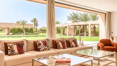 a living room with a couch and a large window at Villa Olfa in Oulad Ikhia