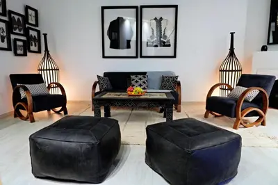 a living room with a couch and a table and chairs at Nassim Al Noor in Marrakech