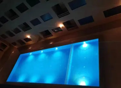 a large blue screen in a room with lights at Le lux de gueliz in Marrakech
