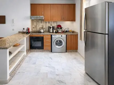 a kitchen with a refrigerator and a dishwasher at Elegant cocoon in Guéliz with 2 bedrooms in Marrakech