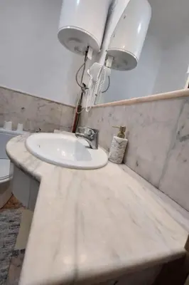 a bathroom with a sink and a lamp on a counter at Elegant cocoon in Guéliz with 2 bedrooms in Marrakech