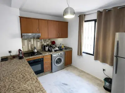 a kitchen with a washing machine and a washer at Elegant cocoon in Guéliz with 2 bedrooms in Marrakech
