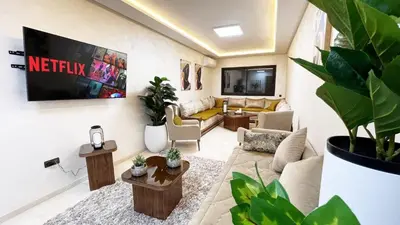 a living room with a lot of plants in it at Marrakech Station Apartment in Marrakech