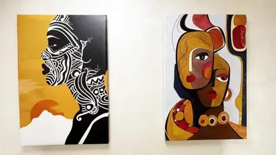 two pieces of art hanging on a wall at Marrakech Station Apartment in Marrakech