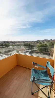 a chair in a room with a large window at Marrakech Station Apartment in Marrakech